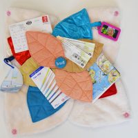 An open Bud sensory cushion holding personal items relating to travelling