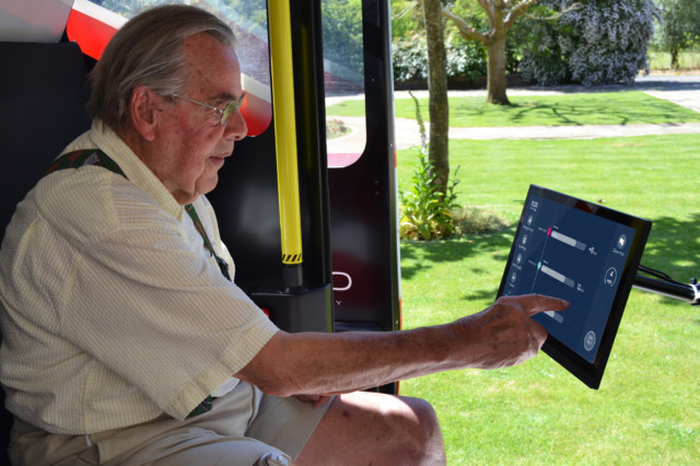 Older man using human machine interace in a driverless car